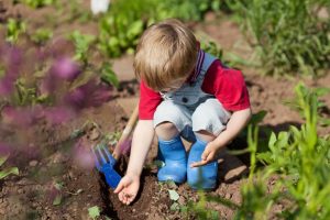 A kid planting a seed.